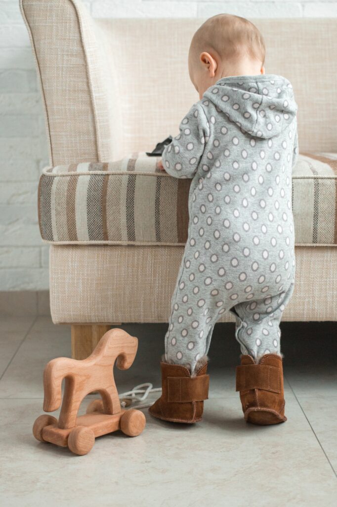 Baby learns to walk along the sofa